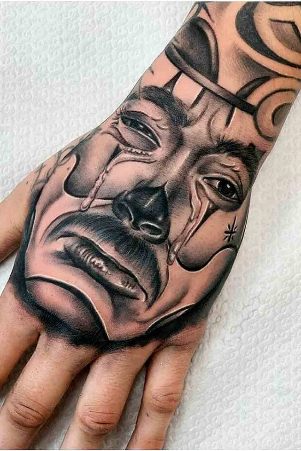 tatuagem-de-palhaco-chorando-na-mao 